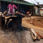 un venditore di carene arrostita in una via di yaoundè in camerun